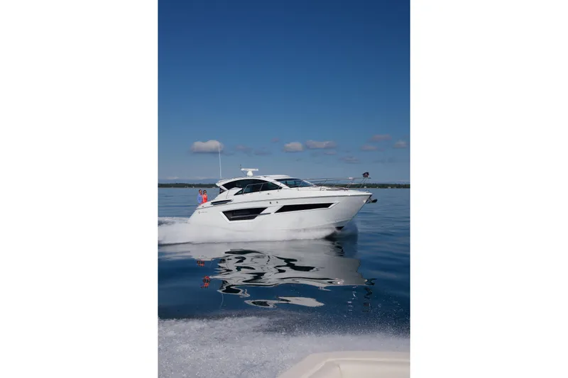  Yacht Photos Pics 2026 Cruisers Yachts 46 Cantius cruising on calm blue waters under clear skies.