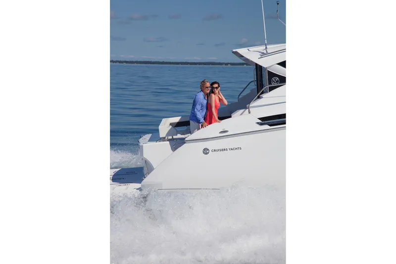  Yacht Photos Pics Couple enjoying a ride on 2026 Cruisers Yachts 46 Cantius, cruising through calm waters.