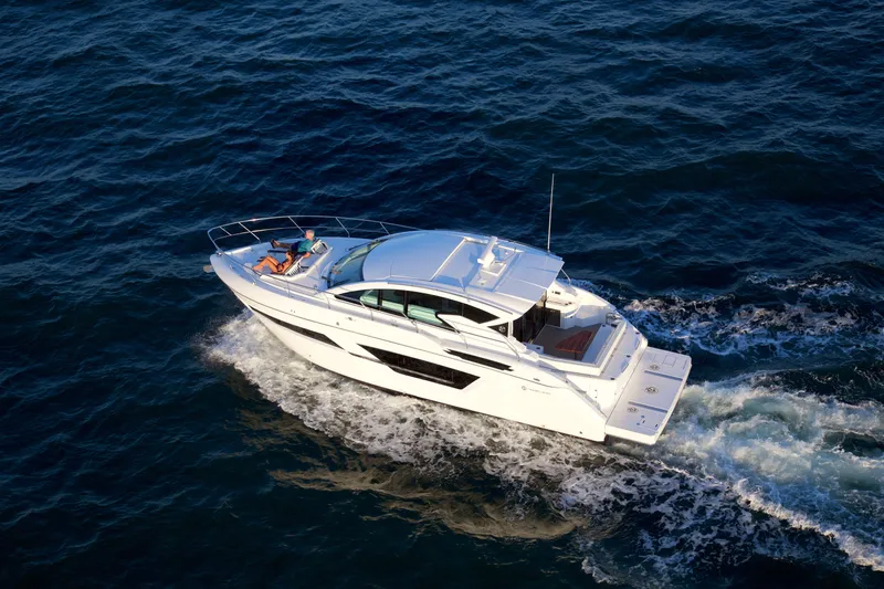  Yacht Photos Pics 2026 Cruisers Yachts 46 Cantius cruising on open water, aerial view.