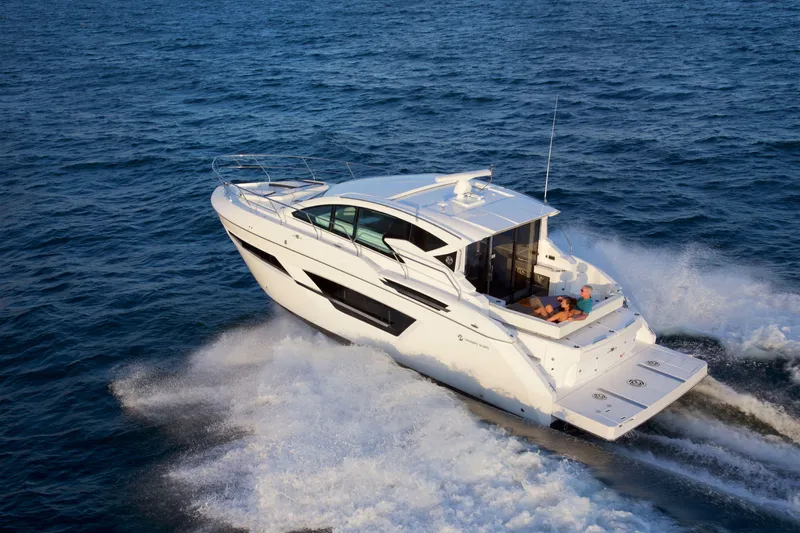  Yacht Photos Pics 2026 Cruisers Yachts 46 Cantius cruising on open water, showcasing sleek design and luxury.