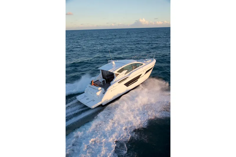  Yacht Photos Pics 2026 Cruisers Yachts 46 Cantius cruising on open sea at sunset.