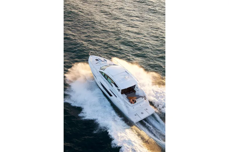  Yacht Photos Pics 2026 Cruisers Yachts 46 Cantius cruising on open water, aerial view.