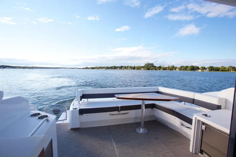  Yacht Photos Pics 2026 Cruisers Yachts 46 Cantius deck with scenic lake view and seating area.