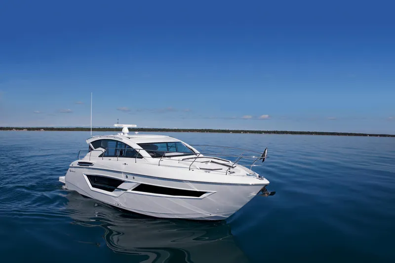  Yacht Photos Pics 2026 Cruisers Yachts 46 Cantius on calm blue water under clear sky.
