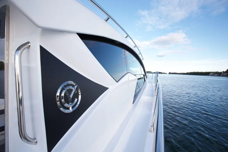  Yacht Photos Pics 2026 Cruisers Yachts 46 Cantius on serene water, showcasing sleek design and luxury.