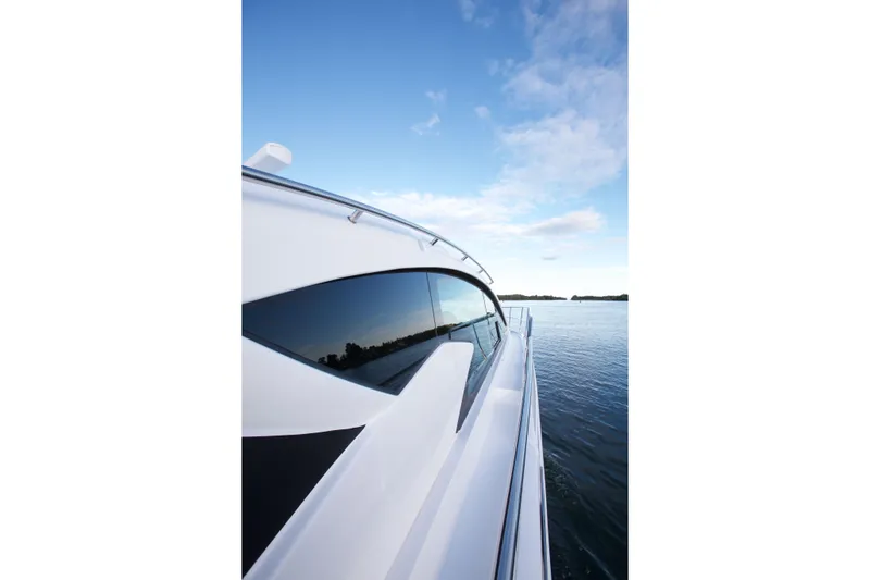 Yacht Photos Pics 2026 Cruisers Yachts 46 Cantius on serene water under blue sky.