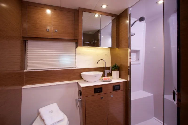  Yacht Photos Pics Luxurious bathroom in 2026 Cruisers Yachts 46 Cantius with modern fixtures and wood accents.