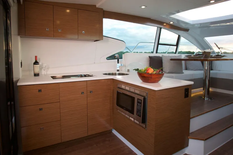  Yacht Photos Pics Luxurious kitchen interior of 2026 Cruisers Yachts 46 Cantius with modern amenities.