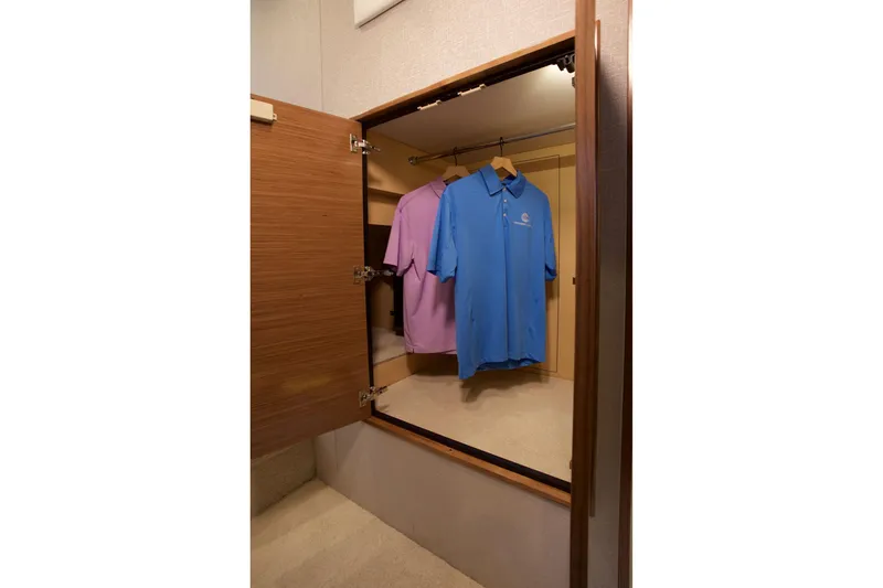  Yacht Photos Pics Open closet with shirts hanging inside the 2026 Cruisers Yachts 46 Cantius.