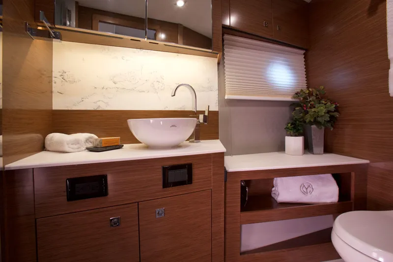  Yacht Photos Pics Luxurious bathroom interior of 2026 Cruisers Yachts 46 Cantius with modern fixtures and elegant design.