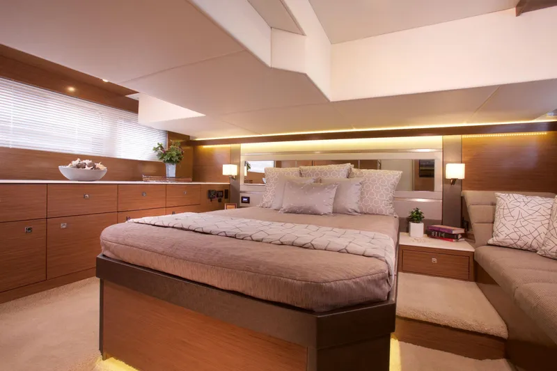  Yacht Photos Pics Luxurious bedroom interior of 2026 Cruisers Yachts 46 Cantius with modern decor and ambient lighting.