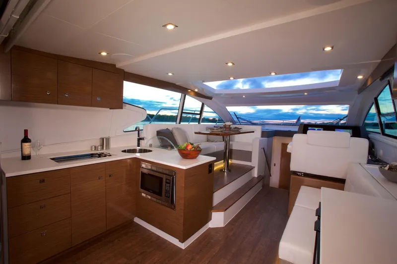  Yacht Photos Pics Luxurious interior of 2026 Cruisers Yachts 46 Cantius with modern kitchen and seating area.