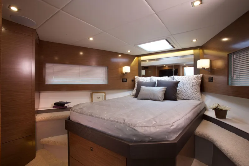  Yacht Photos Pics Luxurious bedroom interior of 2026 Cruisers Yachts 46 Cantius with modern design and cozy lighting.