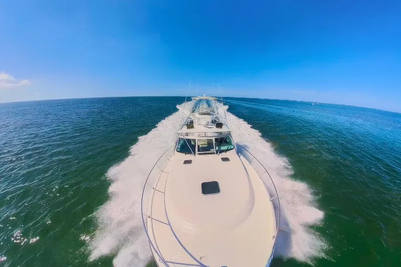 Her Majesty Yacht Photos Pics 2007 Tiara Yachts 3800 Open cruising on open water under clear blue skies.