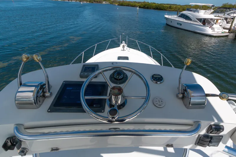 Her Majesty Yacht Photos Pics 2007 Tiara Yachts 3800 Open helm with steering wheel and controls on water.