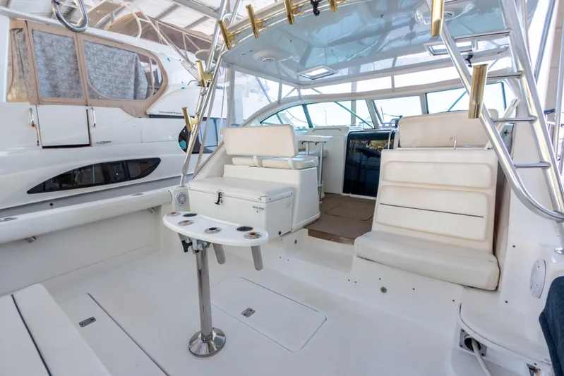 Her Majesty Yacht Photos Pics 2007 Tiara Yachts 3800 Open interior with white seating and fishing rod holders.
