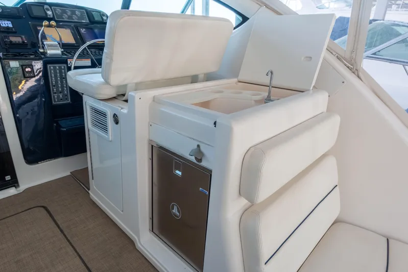 Her Majesty Yacht Photos Pics 2007 Tiara Yachts 3800 Open interior with helm, seating, and compact kitchenette.