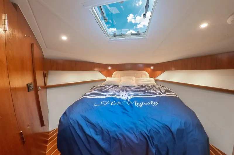 Her Majesty Yacht Photos Pics Luxurious cabin interior of 2007 Tiara Yachts 3800 Open with skylight and cozy bedding.