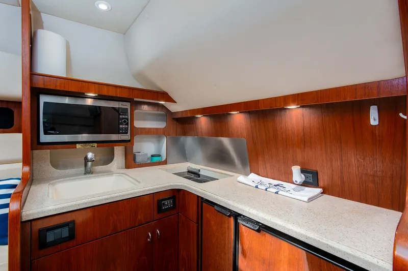 Her Majesty Yacht Photos Pics 2007 Tiara Yachts 3800 Open galley with wood cabinetry and modern appliances.