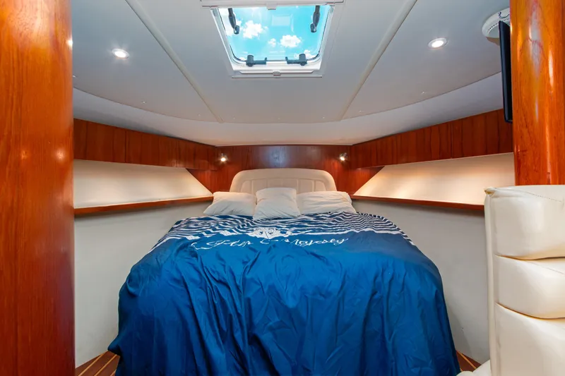 Her Majesty Yacht Photos Pics Luxurious cabin interior of 2007 Tiara Yachts 3800 Open with skylight and cozy bedding.