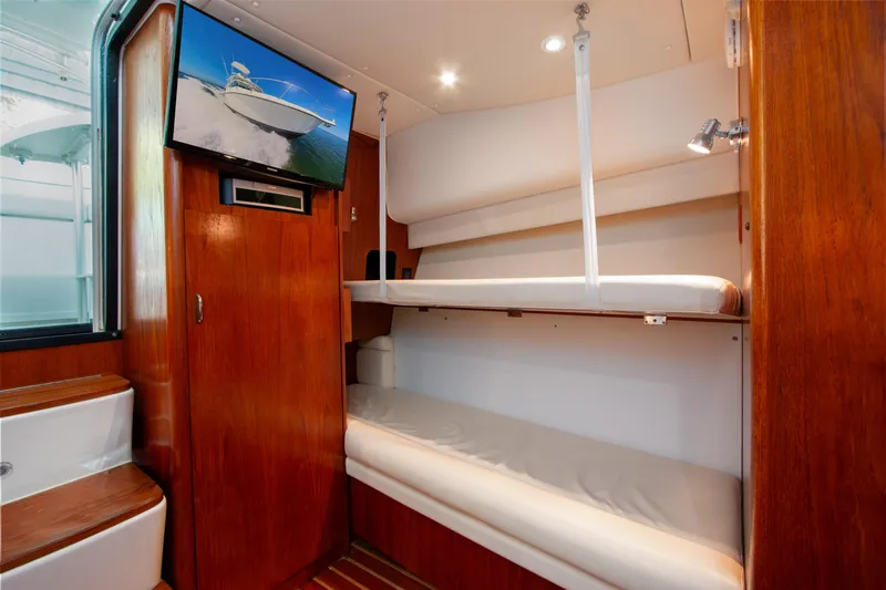 Her Majesty Yacht Photos Pics 2007 Tiara Yachts 3800 Open interior with bunk beds and mounted TV.