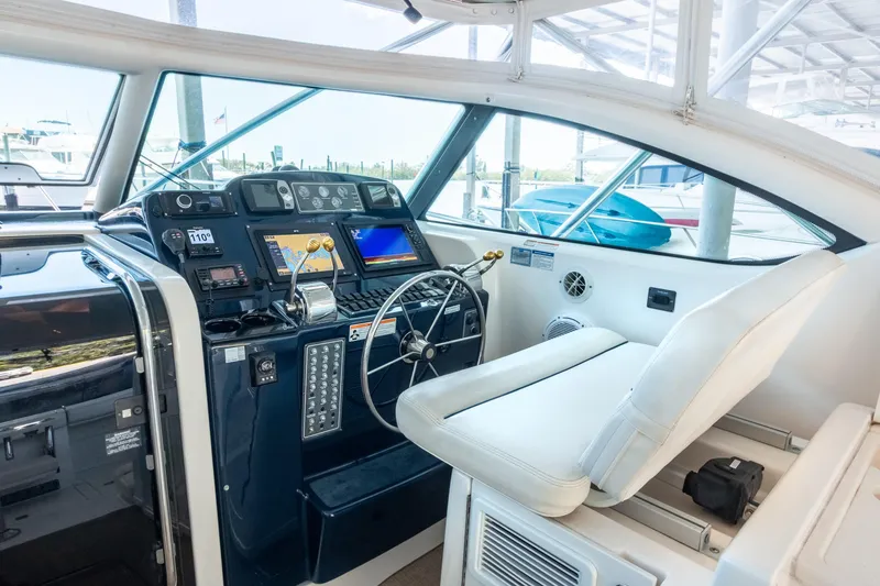 Her Majesty Yacht Photos Pics 2007 Tiara Yachts 3800 Open helm with navigation equipment and white seating.