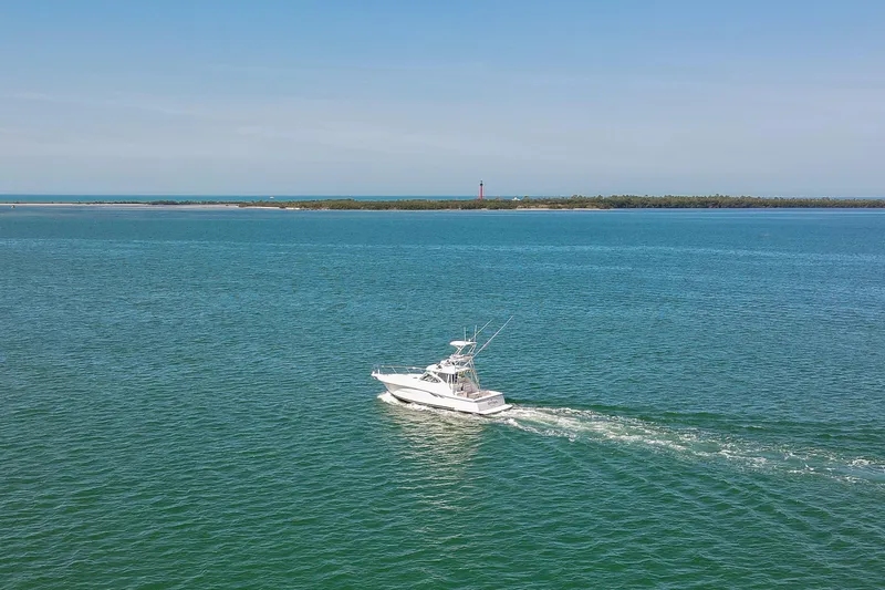 Her Majesty Yacht Photos Pics 2007 Tiara Yachts 3800 Open cruising on open water with distant shoreline.