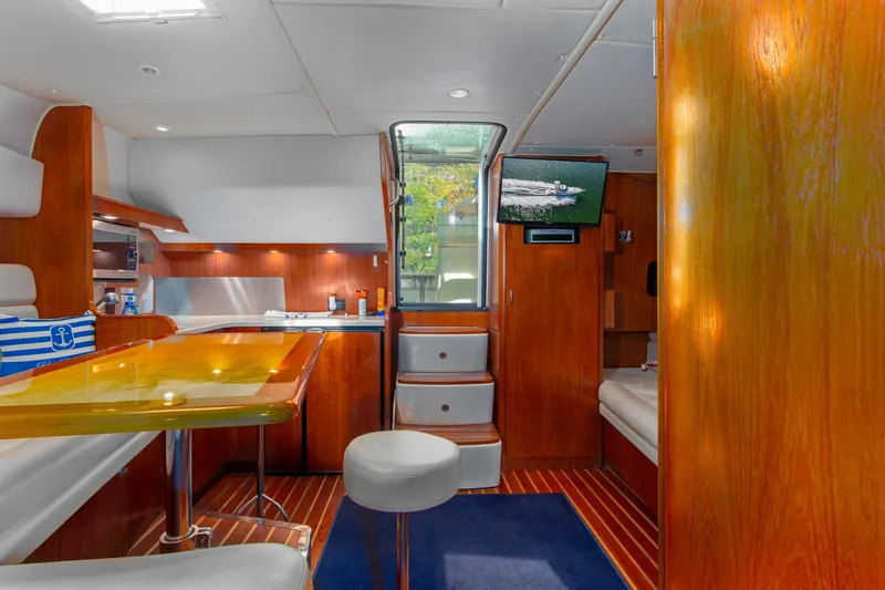 Her Majesty Yacht Photos Pics Luxurious interior of 2007 Tiara Yachts 3800 Open with wood finishes and modern amenities.