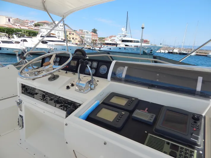  Yacht Photos Pics 1989 Hatteras 45 Convertible yacht helm with navigation instruments, docked in a marina.