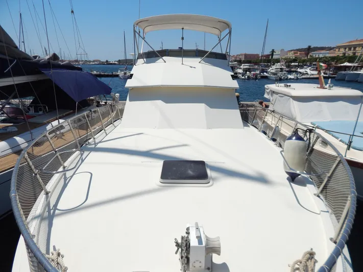  Yacht Photos Pics 1989 Hatteras 45 Convertible yacht docked in a marina, showcasing spacious deck and sleek design.