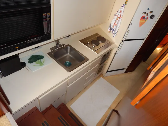  Yacht Photos Pics 1989 Hatteras 45 Convertible yacht kitchen with sink, stove, and refrigerator.