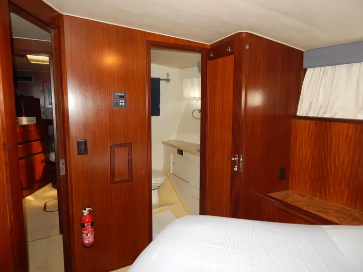  Yacht Photos Pics Interior of 1989 Hatteras 45 Convertible yacht, featuring wood paneling and a compact bathroom.