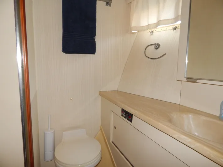  Yacht Photos Pics Bathroom interior of 1989 Hatteras 45 Convertible yacht, featuring sink and toilet.
