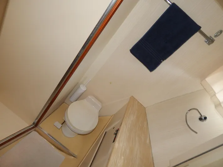  Yacht Photos Pics Bathroom interior of 1989 Hatteras 45 Convertible yacht, featuring toilet and towel rack.