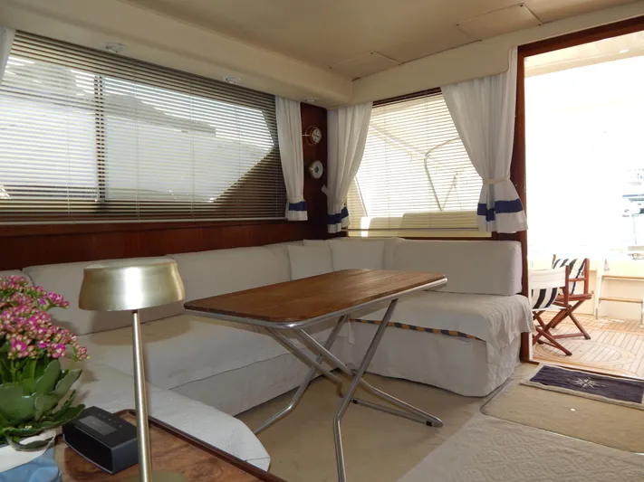  Yacht Photos Pics Interior of 1989 Hatteras 45 Convertible yacht with cozy seating and wooden table.