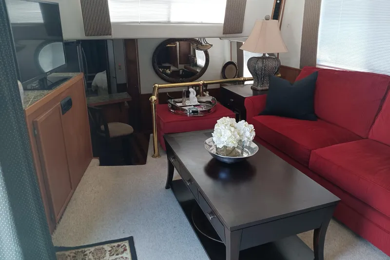 Ski Breeze Yacht Photos Pics Interior of 1996 Harbor Master 52 Wide Body with red sofa and elegant decor.