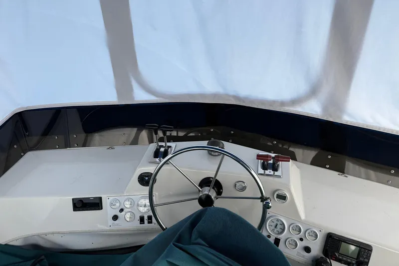 Ski Breeze Yacht Photos Pics Interior helm of 1996 Harbor Master 52 Wide Body boat with steering wheel and controls.