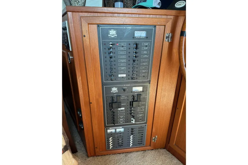 Ski Breeze Yacht Photos Pics Electrical panel on a 1996 Harbor Master 52 Wide Body boat, featuring wooden cabinetry.