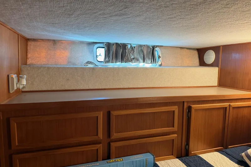 Ski Breeze Yacht Photos Pics Interior of 1996 Harbor Master 52 Wide Body with wood cabinetry and small window.