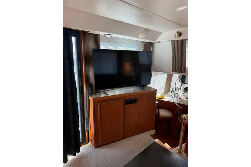 Ski Breeze Yacht Photos Pics Interior of 1996 Harbor Master 52 Wide Body yacht with TV and wooden cabinetry.