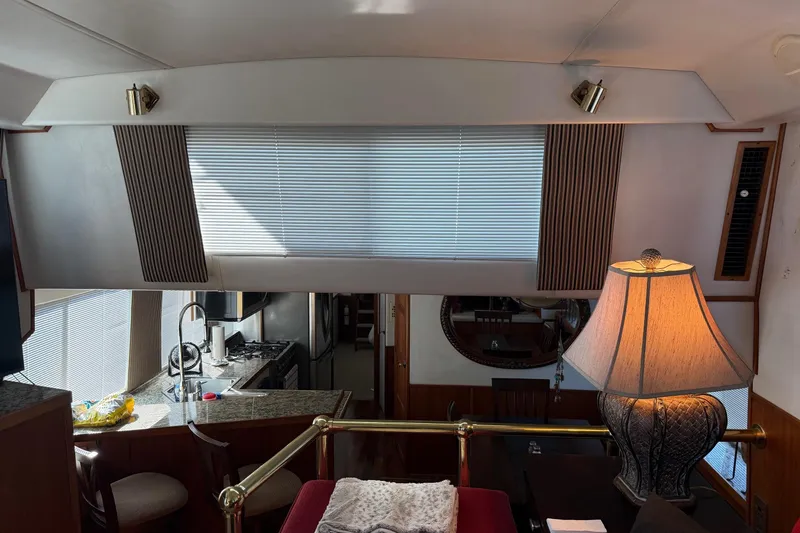 Ski Breeze Yacht Photos Pics Interior of a 1996 Harbor Master 52 Wide Body yacht with kitchen and lamp.