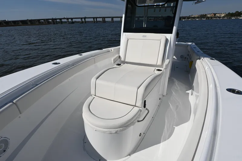  Yacht Photos Pics 2024 Sea Hunt Gamefish 28 boat interior with white seating on calm water.