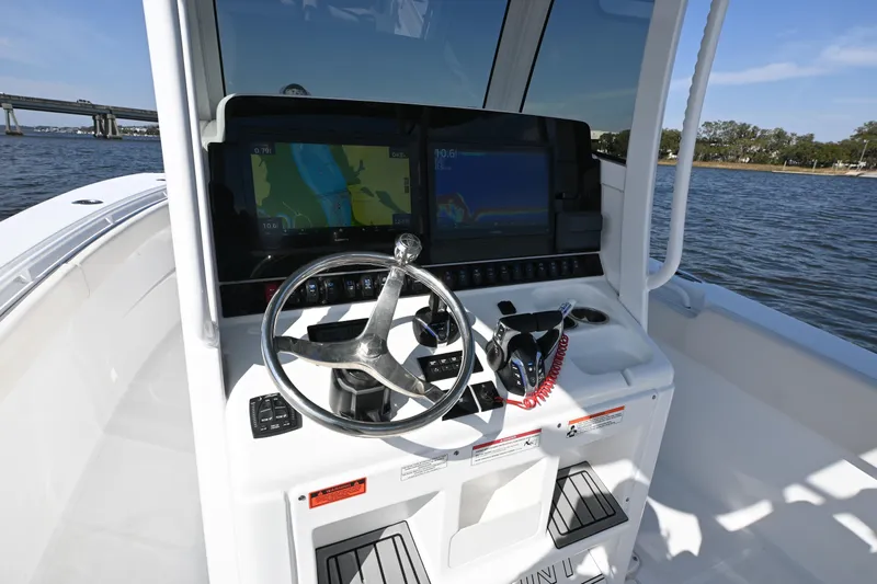  Yacht Photos Pics 2024 Sea Hunt Gamefish 28 helm with dual displays and steering wheel on open water.