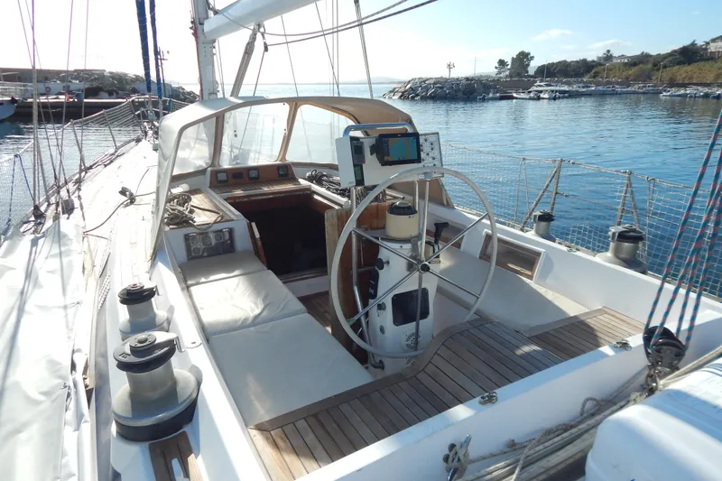  Yacht Photos Pics Sailing yacht Tayana 55, 1992 model, with spacious cockpit and steering wheel, docked at marina.