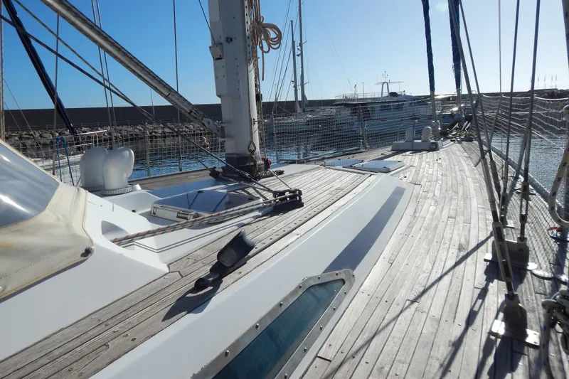  Yacht Photos Pics Sailboat deck view of 1992 Tayana 55, docked in a marina under clear skies.