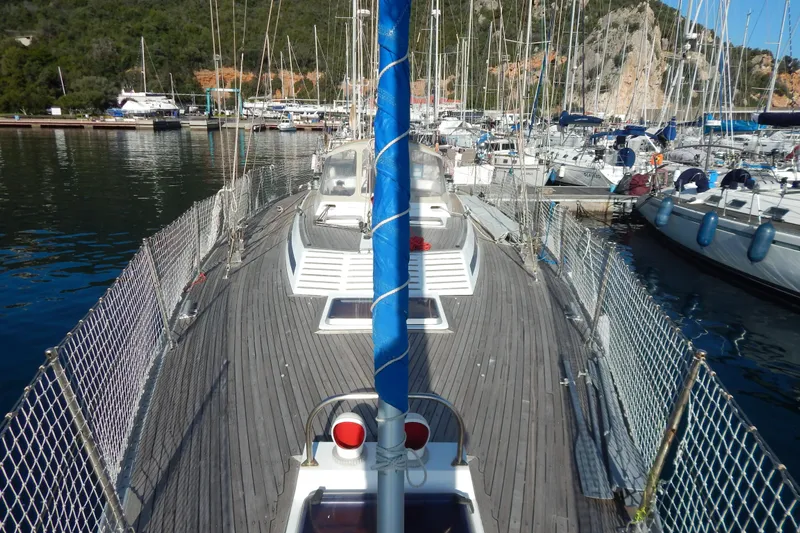  Yacht Photos Pics Sailboat Tayana 55, 1992 model, docked in a marina with surrounding yachts.