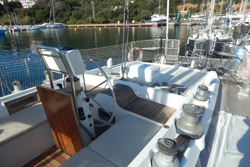  Yacht Photos Pics Cockpit of 1992 Tayana 55 sailboat docked in a marina, featuring steering wheel and winches.