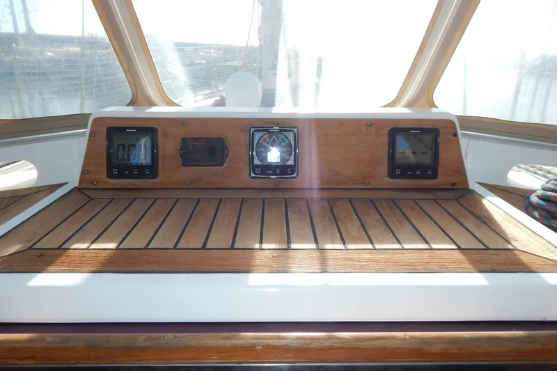  Yacht Photos Pics Cockpit of 1992 Tayana 55 sailboat with navigation instruments and wooden paneling.