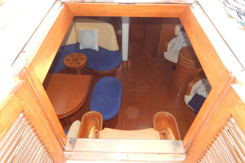  Yacht Photos Pics Interior view of 1992 Tayana 55 yacht, featuring wooden furnishings and blue seating.