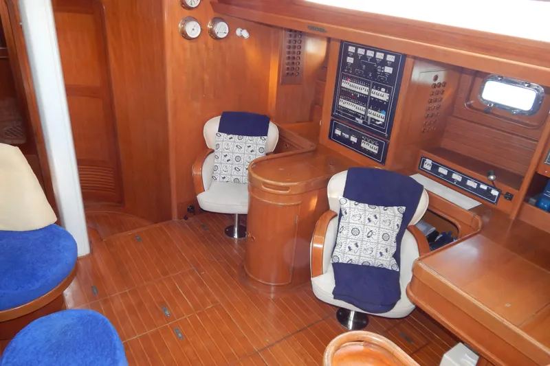 Yacht Photos Pics Interior of 1992 Tayana 55 yacht with wooden paneling and comfortable seating.